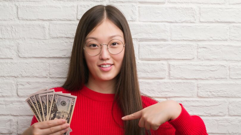 Woman Holding Cash Bills