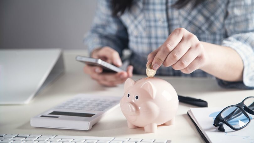 Woman Adding Coin In Piggy Bank Saving Money Calculator Budget Plan