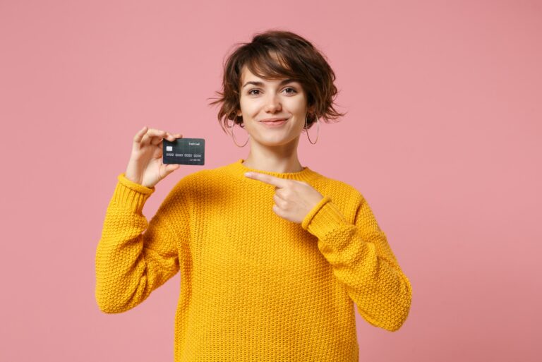 Young Woman Student Pointing To Credit Card Loan