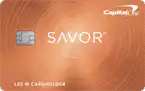 An orange Capital One Savor credit card with a metallic chip on the left and “SAVOR” written in large white letters in the center. The Capital One logo is in the upper right corner.