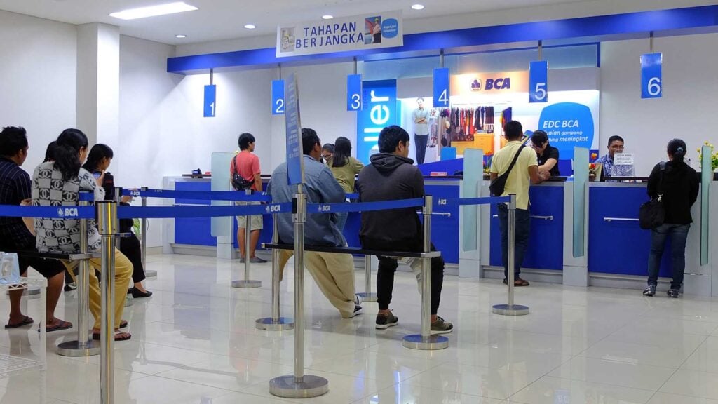 customers and bank tellers inside the bank