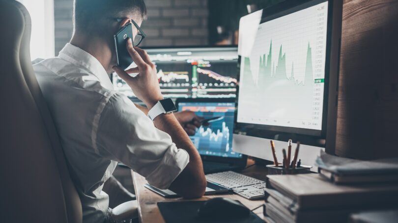 Man Investing Stock Market Computer Screens Working