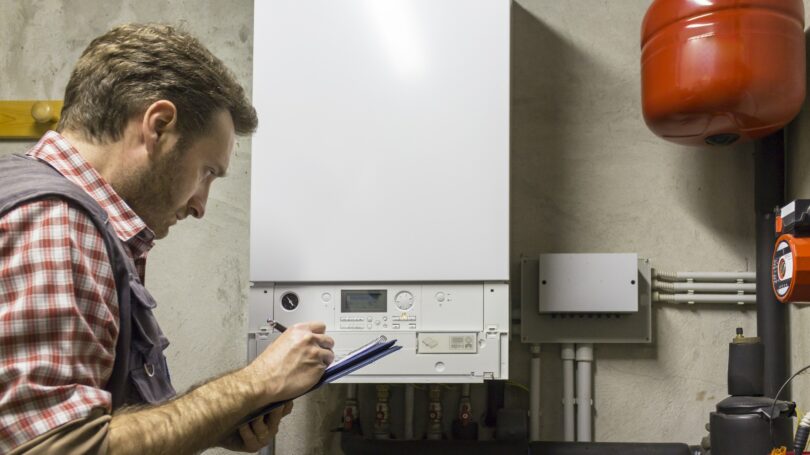 Plumber Working On Maintenance Boiler