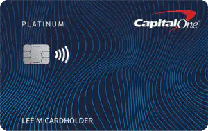 A Capital One Platinum credit card with a dark blue background featuring wavy light blue lines, a silver chip, a contactless symbol, and the name LEE M CARDHOLDER at the bottom.