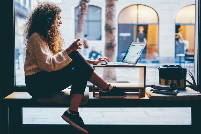 Female Student Siting On Bench Checking Account Online Browsing