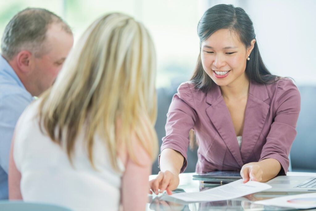 Woman Providing Paperwork Couple