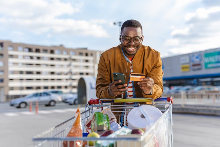 Man Checking Grocery Card Rewards