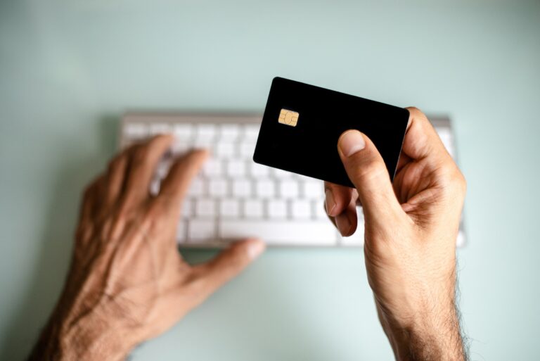 Man Holding Credit Card Keyboard