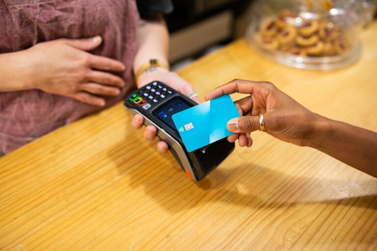 Hand Paying With A Blue Credit Card