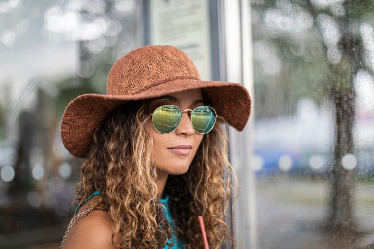 Woman Wearing Hat And Sunglasses While Standing Outdoors