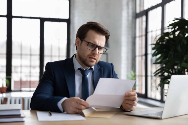 Man Reviewing Letter Unhappy Look