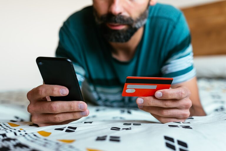 Man Holding Phone Credit Card