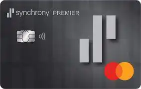 A Synchrony Premier Mastercard credit card with a dark, textured background, chip, contactless symbol, and gray geometric logo on the left. The Mastercard logo is on the lower right corner.