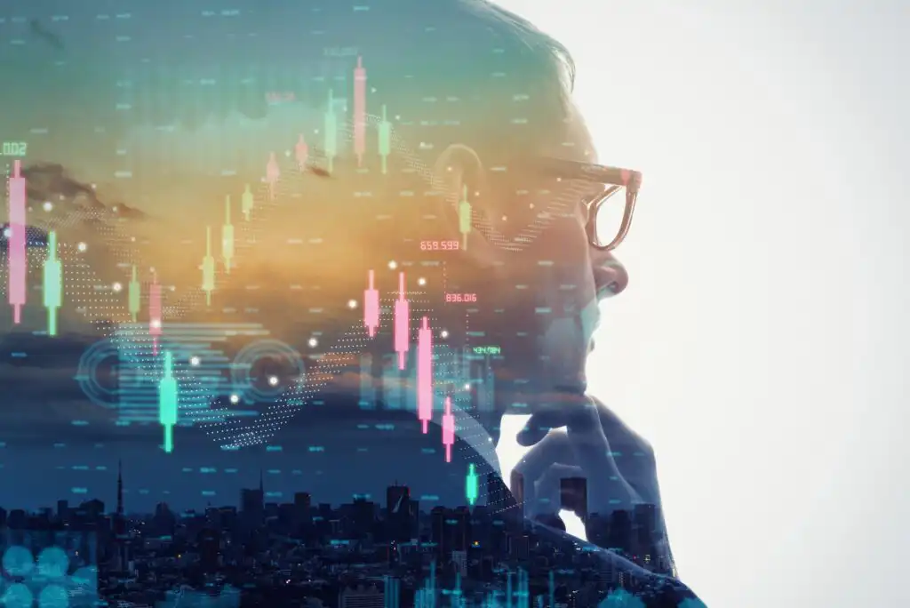 A person in glasses looks thoughtful with hand on chin, overlaid with digital stock charts and bar graphs, set against a cityscape at sunset.