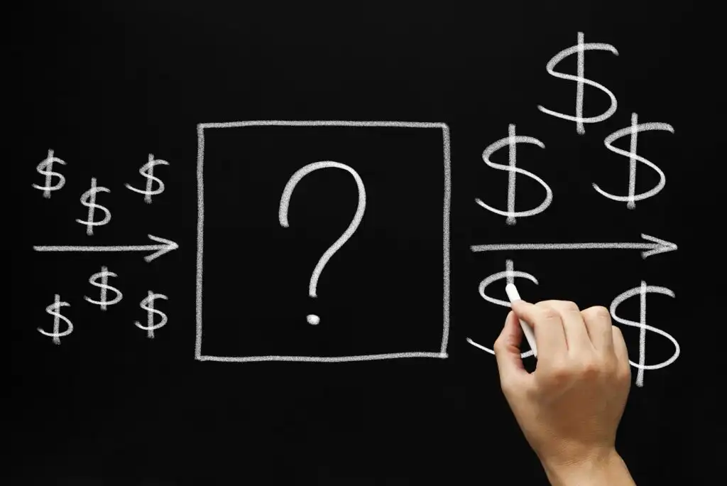 A hand draws a large question mark inside a box on a blackboard, with dollar signs on both sides and arrows pointing from left to right, suggesting uncertainty in a financial process or transaction.