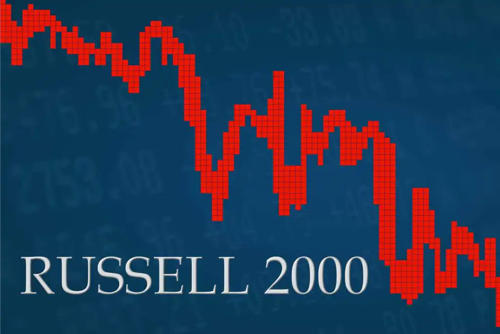 A red pixelated line graph trending downward on a blue background with faint numbers, representing the Russell 2000 index. The text RUSSELL 2000 appears in large white letters at the bottom left.