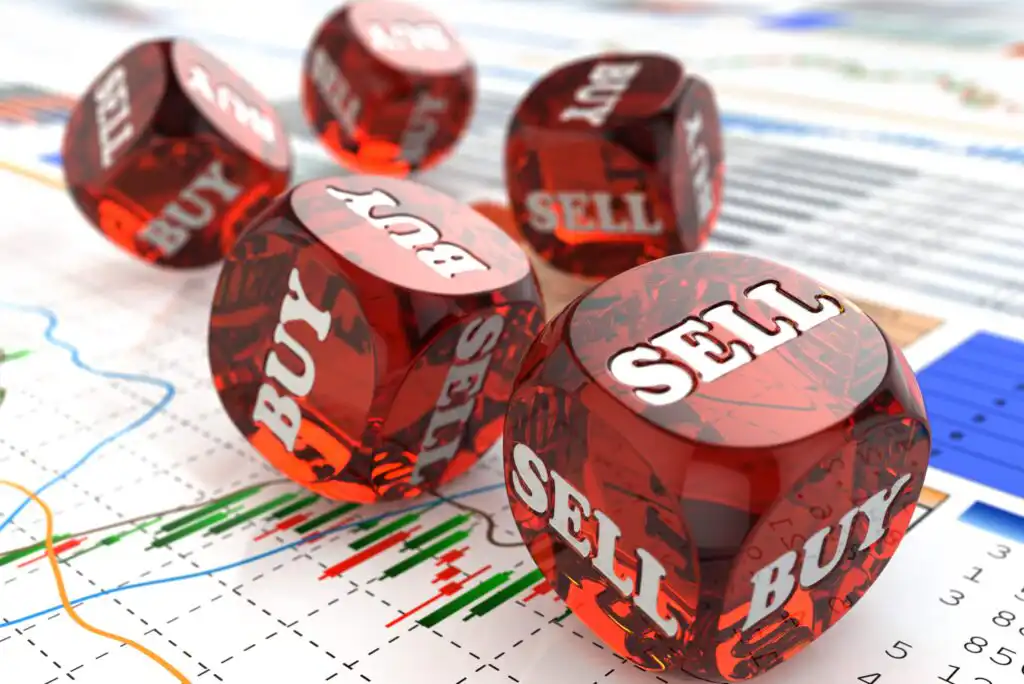 Five red translucent dice with the words BUY and SELL on their faces are scattered on sheets with financial graphs and charts, symbolizing decision-making in stock trading.