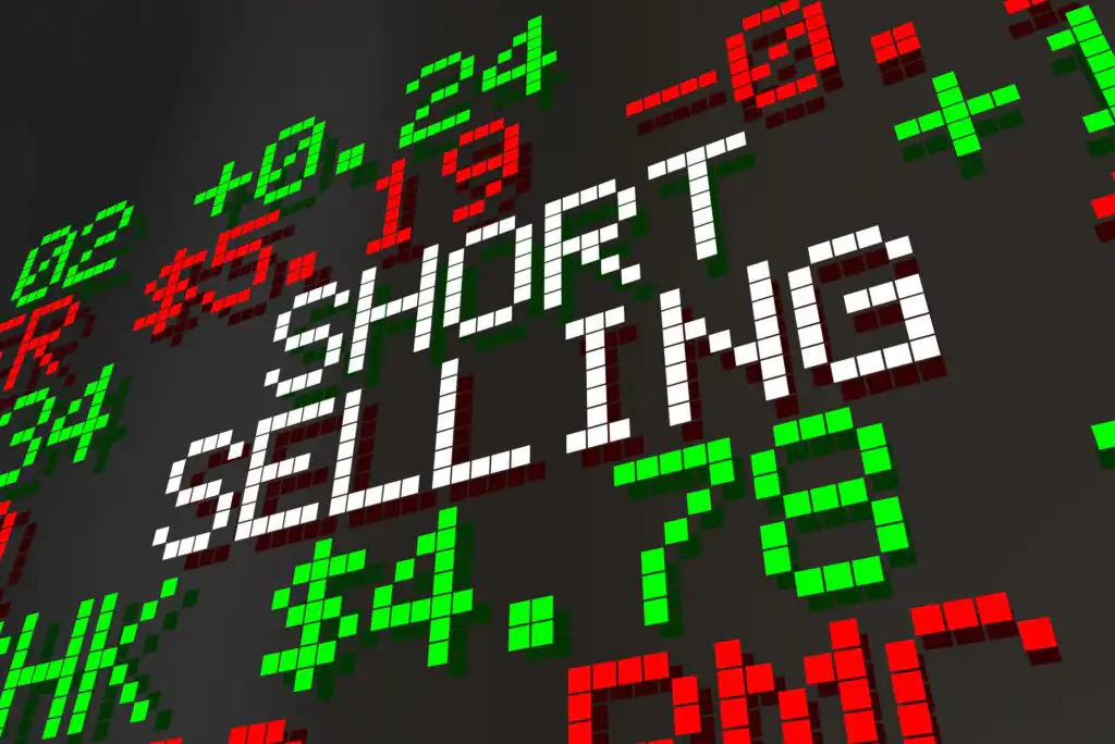 Digital stock market display with the words SHORT SELLING in white pixelated letters, surrounded by red and green stock prices and symbols, representing financial trading activity.