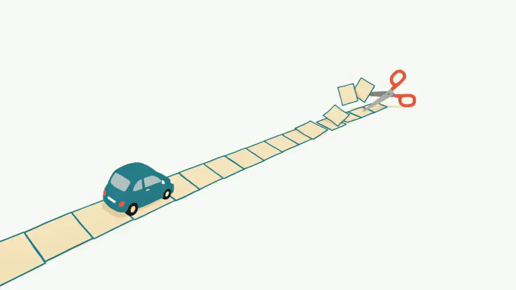 Coral scissors snip the last squares off a paper road ahead of a small teal car