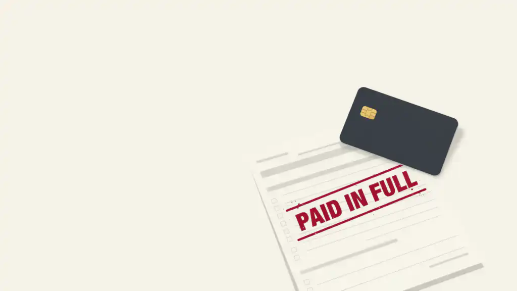 A charcoal charge card rests on a card statement stamped PAID IN FULL in crimson ink.