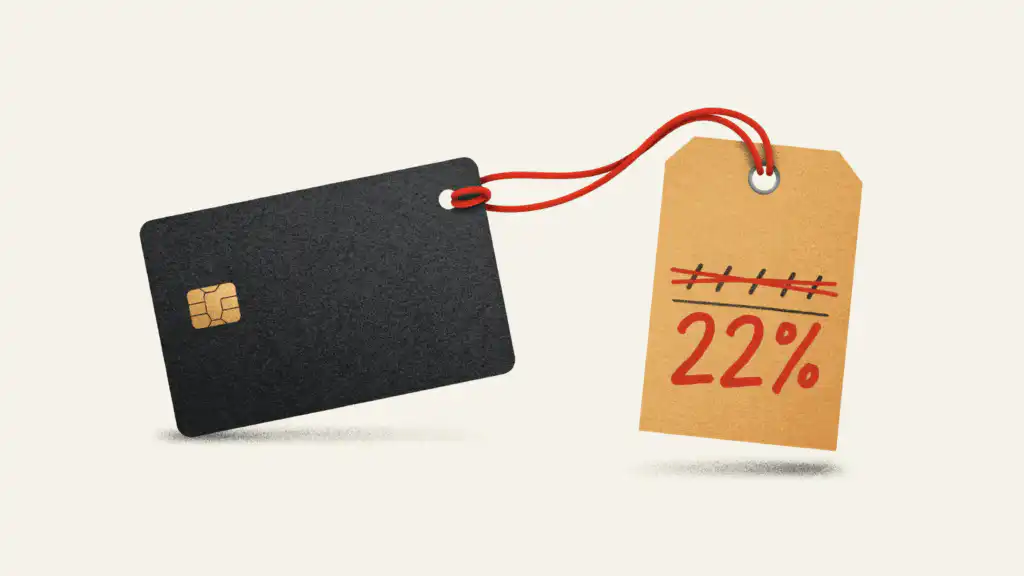 A charcoal credit card tied with red string to a price tag marked down in red to 22%