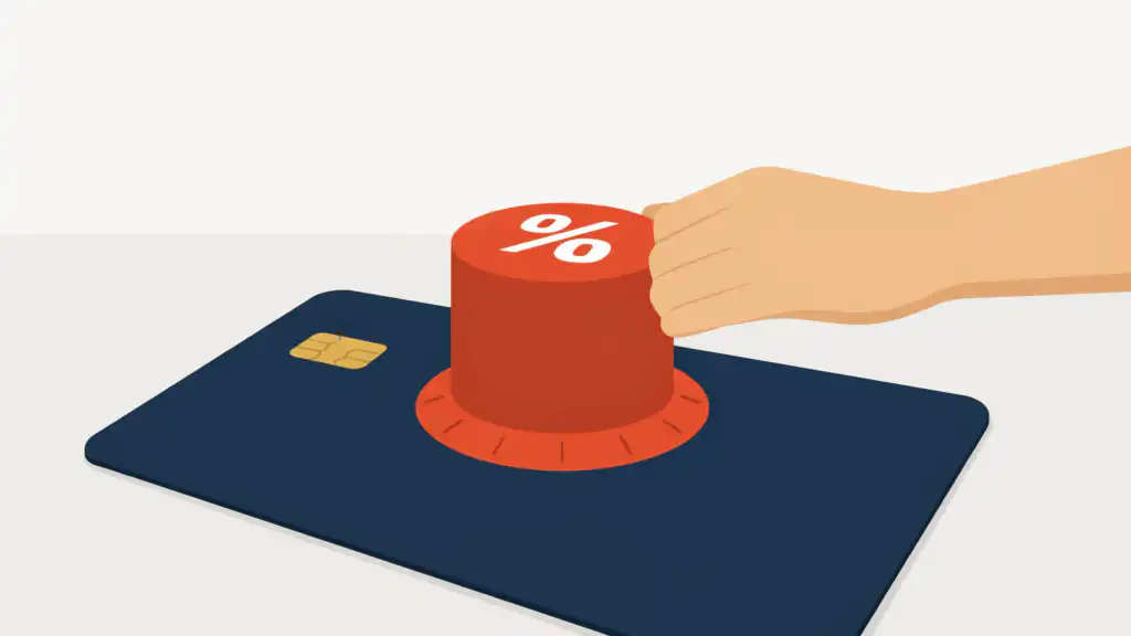 A hand turns a red percent-sign dial on a navy credit card