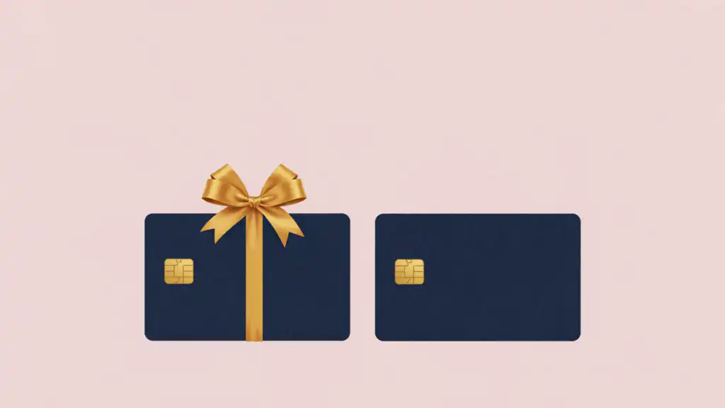 Two identical navy credit cards side by side, one wrapped in a gold ribbon and bow like a present.