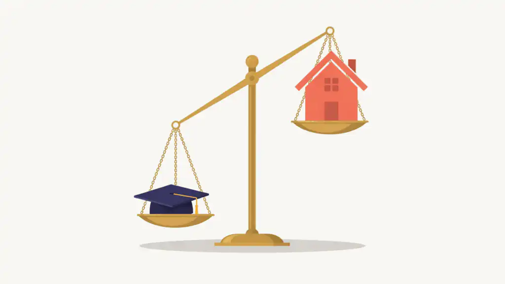 A navy graduation cap outweighs a coral house on a brass balance scale, the cap's pan low and the house's pan high.